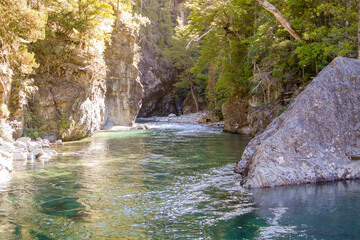 Blue river in the mountains and forest, in the afternoon during summer in Chubut, Patagonia Argentina
