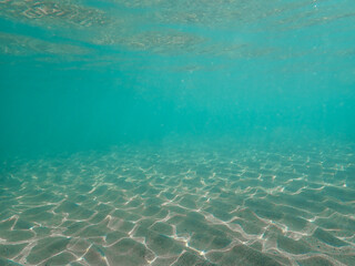 aquatic background, Underwater Blue Ocean, Sandy sea bottom Underwater background, summer time under sea ocean in clean and clear water with ray of sunlight from surface for background concept design