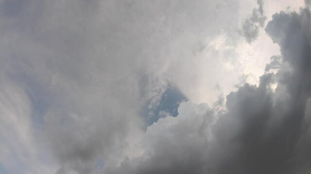 gray stormy clouds dramatic nature cloudy in pastel blue sky, dark clouds rolling in to high heavenly sky space in rainy day, rainstorm weather in summer season. beautiful wide angle view cloudscape