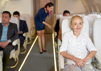 Happy old woman in airway flight on boarding for travel with airplane