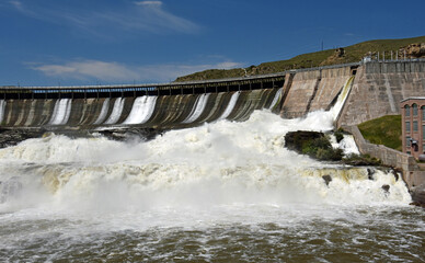 ryan hydroelectric dam and the missouri river on a sunny summer  day, near great falls, montana