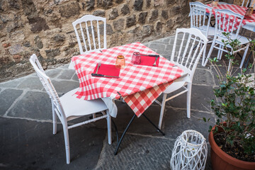 Set Table on a Street in Montalcino, Tuscany, Italy, with Checkered Red and White Tablecloth, in the Old Town