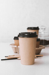 Paper disposable brown cup  coffee, latte or or any other drink on a table