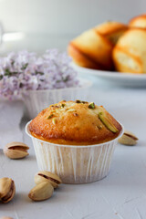 Lemon muffins sprinkled with chopped pistachios.