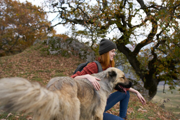 woman hiker next to dog on nature travel landscape