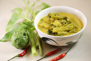 Morning Glory with Pork Belly curry paste with Coconut milk Thai called *Kang te pho* thai food in white bowl