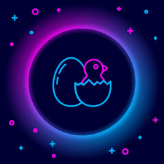 Glowing neon line Little chick in cracked egg icon isolated on black background. Colorful outline concept. Vector