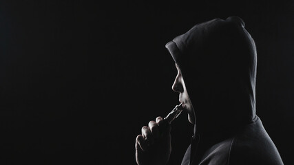 Photo of man with the vape in hood