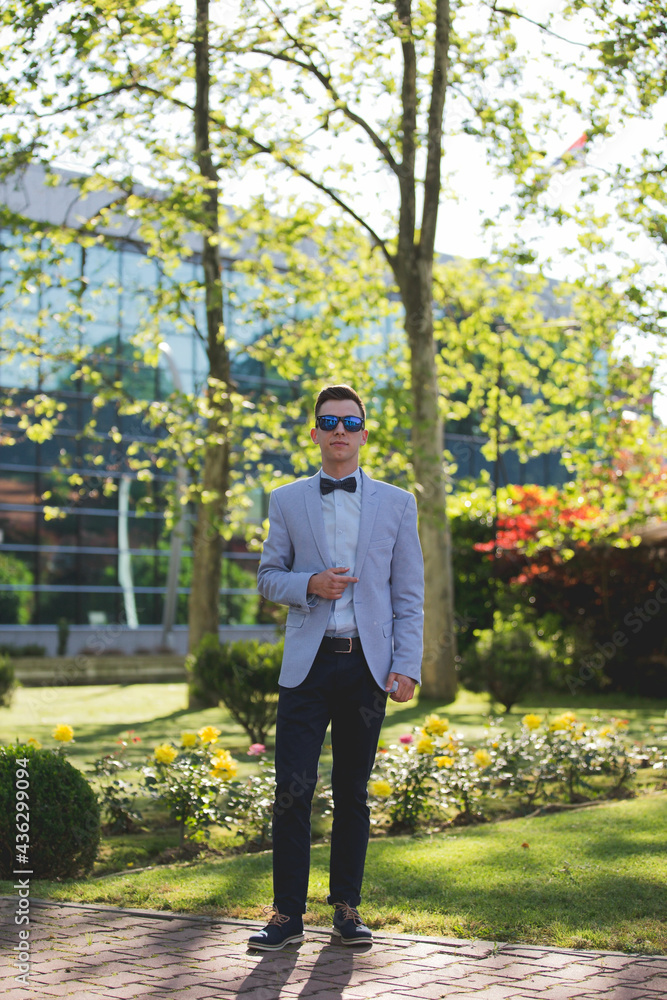 Wall mural young caucasian businessman posing outdoors