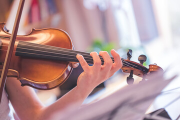 Practicing classical music and violin concept: Young girl happily plays on her new violin