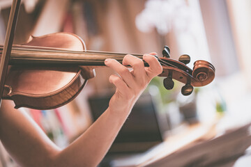 Practicing classical music and violin concept: Young girl happily plays on her new violin