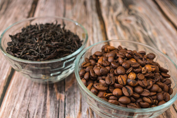 Roasted coffee beans in a bowl and brewed tea in the background