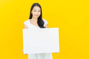 Portrait beautiful young asian woman with empty white billboard