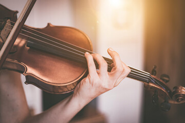 Practicing classical music and violin concept: Young girl happily plays on her new violin