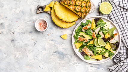 Fototapeta na wymiar Grilled chicken breast, pineapple, green rocket salad, lime and olive oil. Healthy juicy food. banner, menu recipe place for text, top view