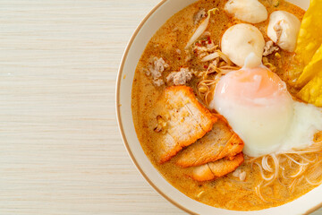 Rice vermicelli noodles with meatball, roasted pork and egg in spicy soup