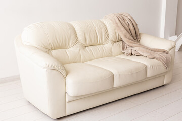 Beige sofa in room on white background. Simple minimalistic design.