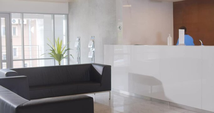 People sitting in waiting room of modern medical clinic.