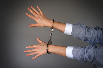 Arrested woman handcuffed hands. Prisoner or arrested terrorist, close-up of hands in handcuffs...