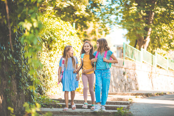 Three little girls going to school.