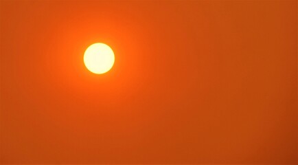 Close up of an orange sun with wild fire smoke in the air