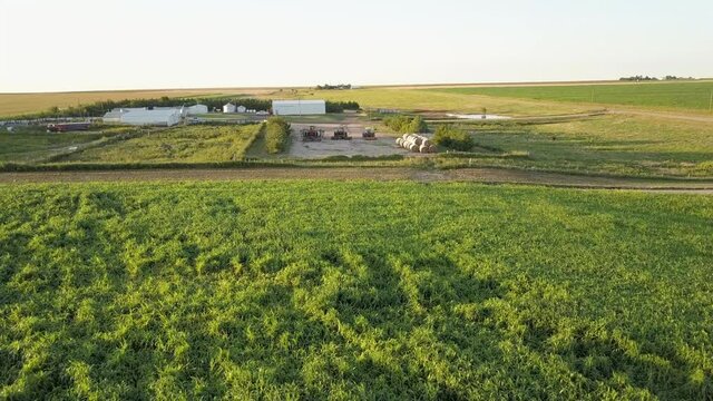 Aerial Forward Beautiful Scene Of Filed Against Clear Sky, Drone Flying Over Tractors On Landscape During Sunny Day - Oakley, Kansas