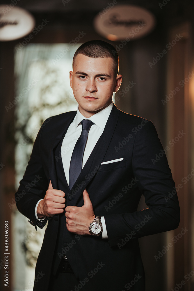 Poster vertical shot of a handsome bosnian caucasian man wearing a suit, posing indoors