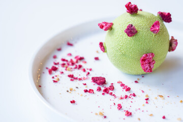 Obraz na płótnie Canvas Tasty pistachio - raspberry pie on a white plate.