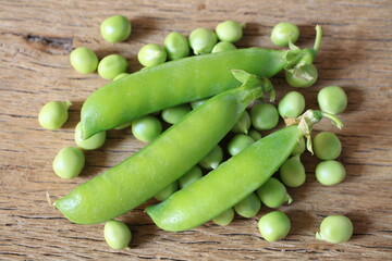 Fresh green pea pod with beans isolated on white background.  