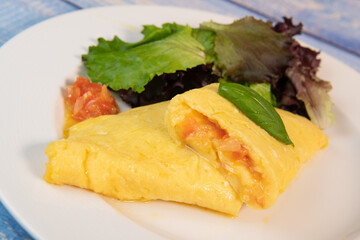 Omelette with salmon and herbs, served on plate, traditional Norwegian dish, High quality photo