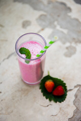 strawberry smoothie or milkshake in glass. Healthy food for breakfast and snack.