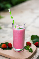 strawberry smoothie or milkshake in glass. Healthy food for breakfast and snack.