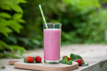 strawberry smoothie or milkshake in glass. Healthy food for breakfast and snack.