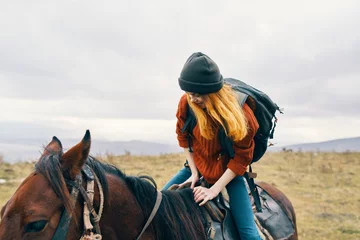 Foto op Canvas woman tourist sitting on horse fresh air adventure ride © SHOTPRIME STUDIO