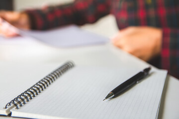 education at the home concept - black pencils close up and composition notebook backdrop with...