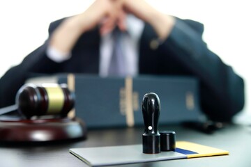 Lawyer with gavel and stamp on desk