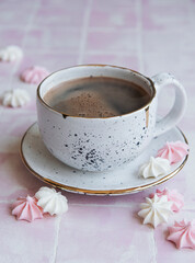 Cup with coffee and small meringues