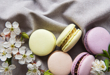 Fototapeta na wymiar French sweet macaroons colorful variety on a gray textile background