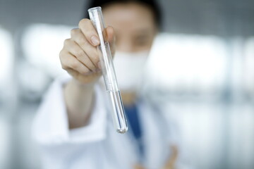 Close up of doctor holding test tube. Biotechnology,medicine,chemistry concept