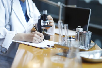 Doctor using microscope in laboratory