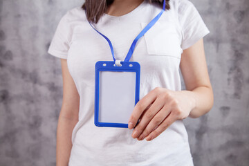 young girl holds id card