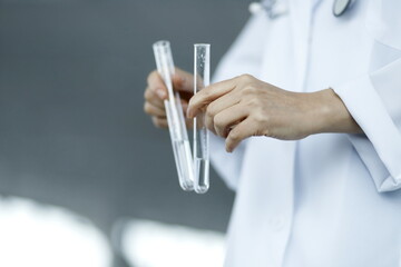Close up of doctor holding test tubes. Biotechnology,medicine,chemistry concept