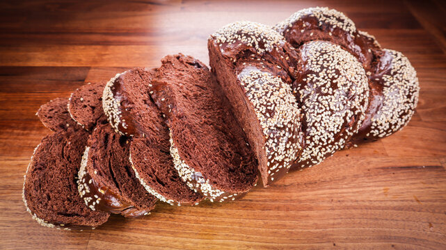 Closeup Of Sliced Chocolate Challah On A Wooden Ta