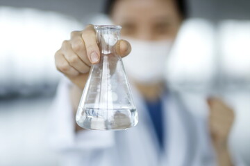Doctor holding flask. Biotechnology,medicine,chemistry concept