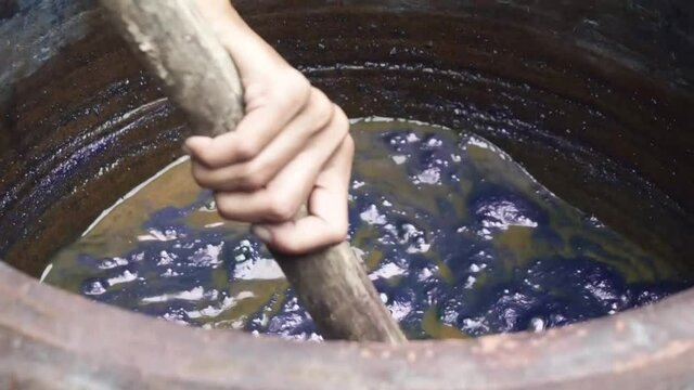 Handmade traditional technique of fabric dyeing in natural indigo colour in Thailand