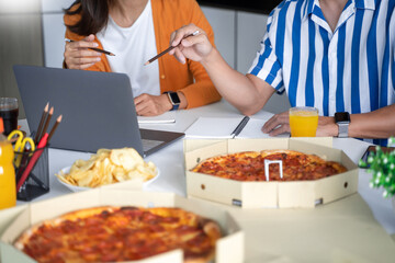 group of business people talking about project and prepare pizza and potato chips for having lunch in corporate together in office.