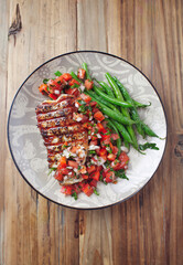 Grilled steak with Green Beans and Salsa. Wooden background. Top view. Copy space. 