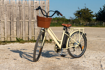 Electric bicycle wide padded seat and minimalist swan style handlebars. luggage rack. The open style frame. Battery-powered peddling assist ebike