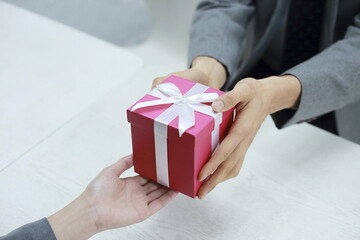 Close up of couple holding gift box