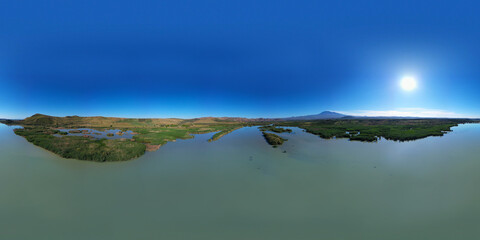 360 degrees aerial photo of the Oasis of Ponte Barca a protected area in the heart of Paternò in Sicily. Wetland that attracts numerous waterfowl. Nesting place of the Sultan chicken. Etna view.